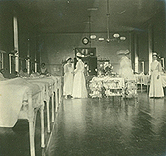 Nurses conferring on patient ward